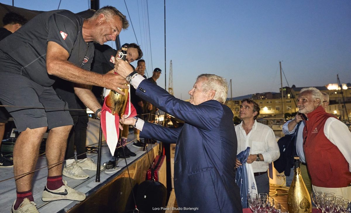 YCCS President Carlo Cameli presents SHK Scallywag skipper David Witt with some liquid refreshment for the crew. Photo: Loro Piana/Studio Borlenghi